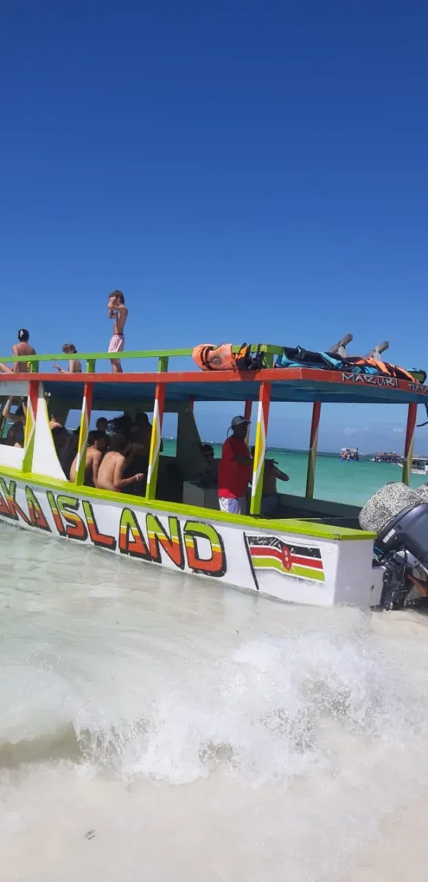 The excursion boat with a wave breaking in the foreground on the sandbank.