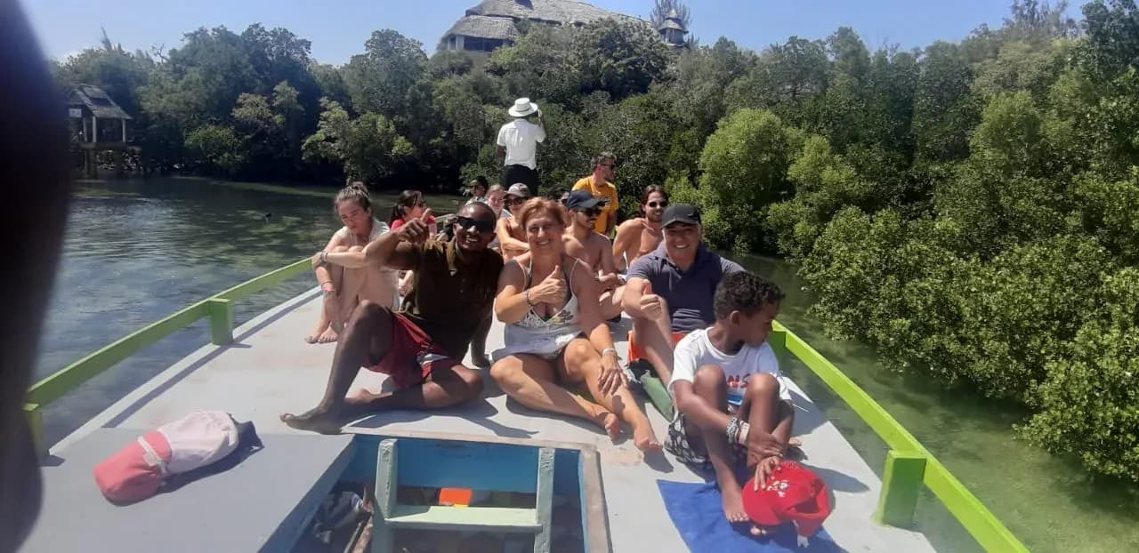 Guests sitting in the bow as the boat passes through the mangroves.